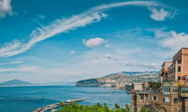 A stunning summer day view of a marina bay, bathed in golden sunlight in Sant'Agnello, Italy