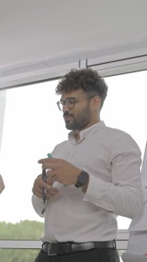 A vibrant and dynamic interaction takes place during a professional presentation in a contemporary office setting