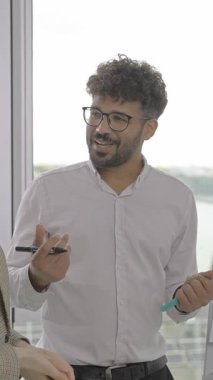 A skilled professional shares innovative ideas enthusiastically in a collaborative meeting in a modern office