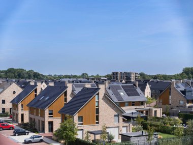 Aerial view of modern sustainable housing community with solar panels and green design