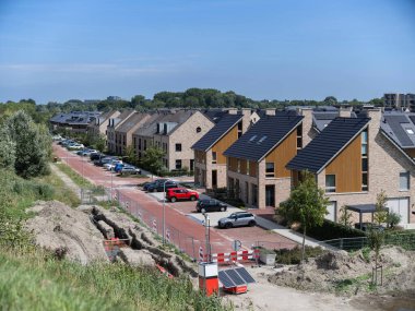 Modern housing development under construction showing sustainable building practices and infrastructure