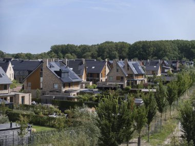 Modern houses with solar panels and sustainable design features in residential development