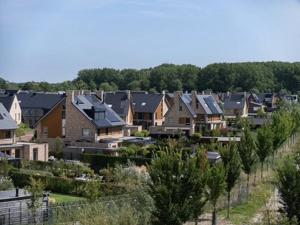 Modern houses with solar panels and sustainable design features in residential development