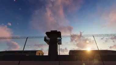 Günbatımında dikenli tellerin arkasında hapis