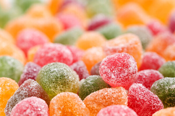 Close up of a variety of mint jelly bonbons with sugar crystals icing in different flavors and colors. Macro food background texture