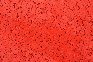 Kırmızı renkli kauçuk zemin arka plan doku. Şok emici spor salonları, oyun alanları, spor ve koşma parça için döşeme
