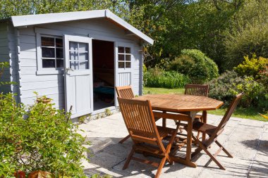 Shed with terrace and garden furniture clipart