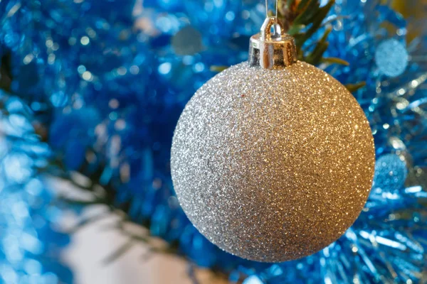 Silvery Christmas balls and blue tinsel on a Christmas tree — Stock Photo, Image
