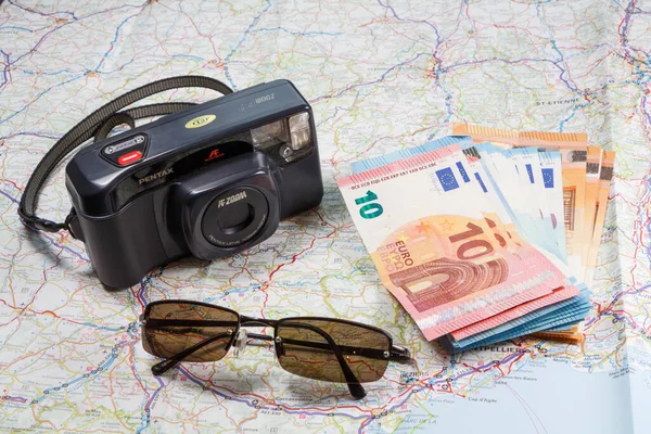 Primelin - France, January 24, 2018 : Roadmap, Pentax camera, sunglasses and euro notes