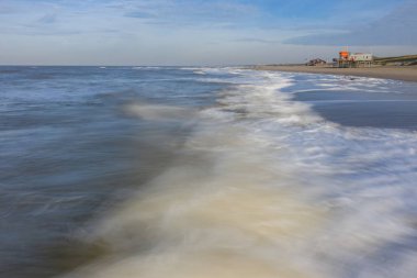 Kuzey Denizi hareket dalgalar ve sahilde bir cankurtaran kulesi
