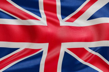 Rüzgarda dalgalanan Birleşik Krallık bayrağı, kumaş kıvrımlı ve dalgalı gerçekçi ulusal bayrak, özgürlük, birlik, miras ve vatansever kimliğin sembolü.