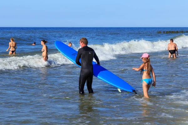 Zelenogradsk, Kaliningrad bölgesi, Rusya Federasyonu - 29 Temmuz 2017: Bilinmeyen sörfçü ile Baltık Denizi'nin mavi sularına yaz zaman sörf tahtası ayakta.