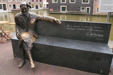 AMSTERDAM, NETHERLANDS - JUNE 25, 2017: Sculpture of the Alida Bosshardt, better known as Major Bosshardt. She was a well known officer in The Salvation Army, and public face of this organization. clipart