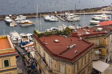 NAPLES, ITALY - OCTOBER 31, 2015: Air view of the old shabby buildings of Naples near gulf embankment. Viiw from the castle Castel dell'Ovo.