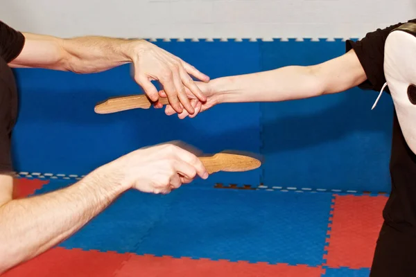 Human hands with wooden knives during training of martial arts. — Stock Photo, Image