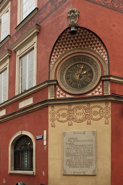 Große antike Uhr als Teil der Dekoration an der Ecke eines der historischen Häuser in der Warschauer Altstadt. — Stockfoto