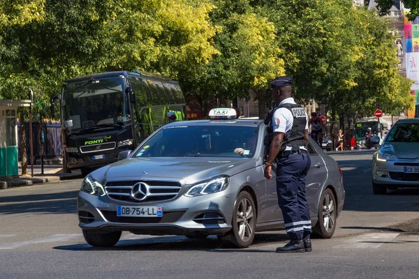 Oficial de policía regula el tráfico en la carretera en el centro de París . — Foto de Stock
