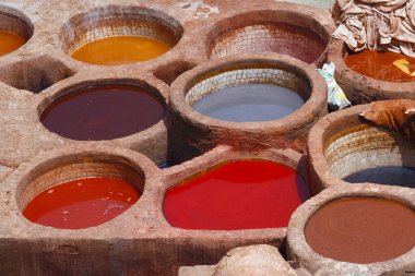 Old tannery in Fez, Morocco. The tanning industry in the city is considered one of the main tourist attractions. The tanneries are packed with the round stone wells filled with dye. clipart