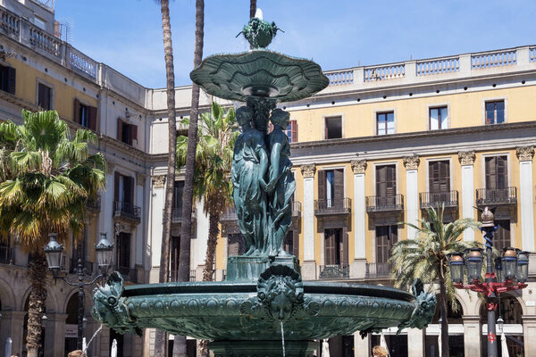 BARCELONA, SPAIN - MAY 15, 2017: Details of the old fountain in the Placa Reial (Royal square in english, Plaza Real in spanish) in Gothic quarter. 
