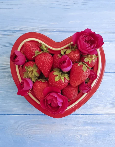 strawberry dish heart, flower rose on colored wooden background, banner