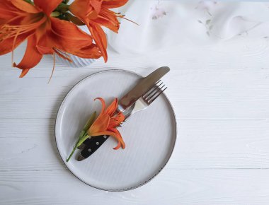 turuncu lily çiçekler tabak çatal bıçak bir ahşap arka plan Tekstil