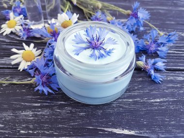 Krem Kozmetik çiçek peygamber çiçeği, papatya koyu ahşap arka plan üzerinde