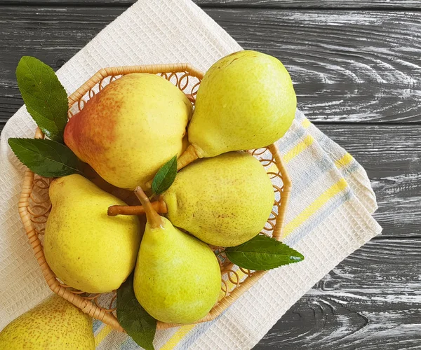 ripe organic pear on a black wooden background