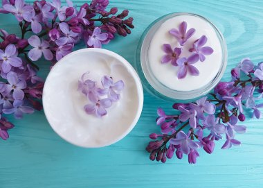 mavi ahşap arka plan üzerinde kozmetik krem Lila çiçek
