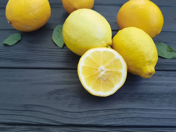 fresh lemon on a black wooden background