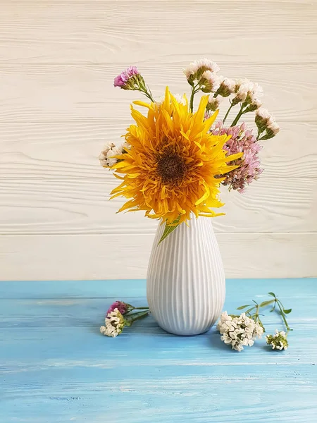 vase autumn flowers, sunflower on a wooden background
