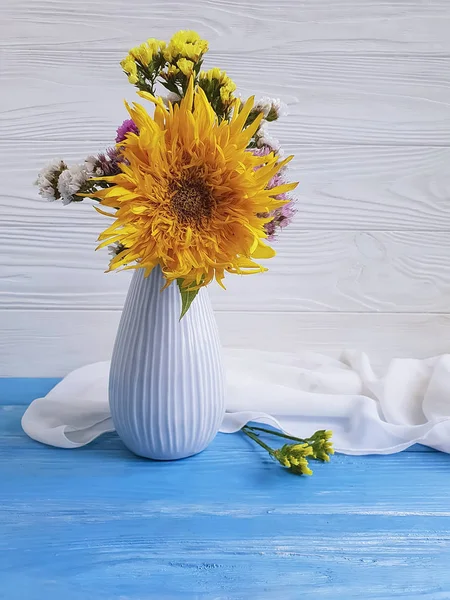 vase autumn flowers, sunflower on a wooden background