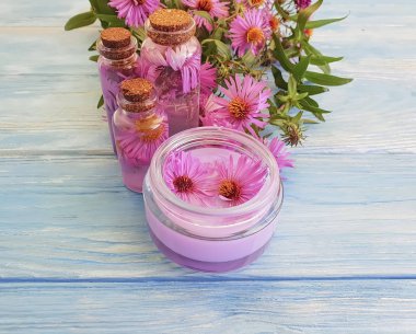 kozmetik krem, özü, mavi ahşap arka plan üzerinde kasımpatı çiçeği