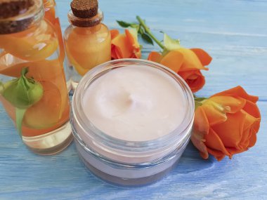 kozmetik krem, gül çiçek özü, ahşap arka plan üzerinde mum