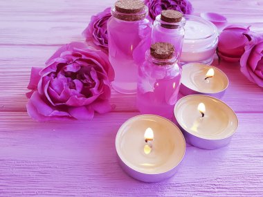 Krem Kozmetik, özü, gül çiçek, pembe ahşap zemin üzerine mum