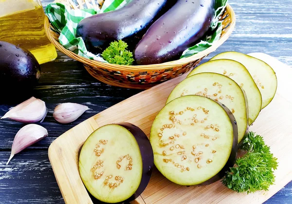 eggplant sliced on wooden background wooden background