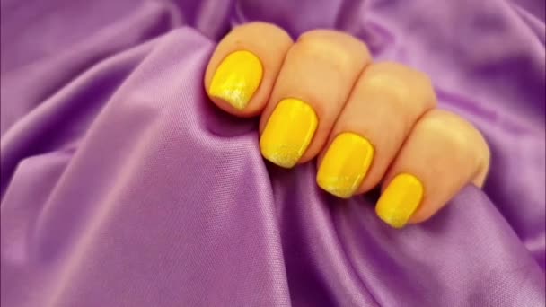 Female Hand Yellow Manicure Silk Fabric — Stock Video