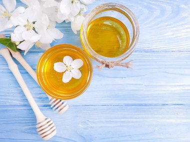 fresh honey, blooming apple tree, wooden background
