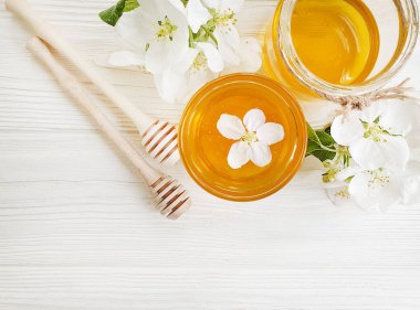fresh honey, blooming apple tree, wooden background