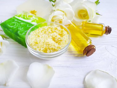 tuz, yağ, sabun çiçeği beyaz ahşap arka plan üzerinde gül