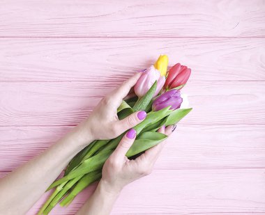 ahşap arka plan üzerinde lale kadın eller manikür buketi