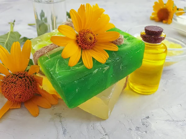 cosmetic cream, calendula flower soap on concrete background