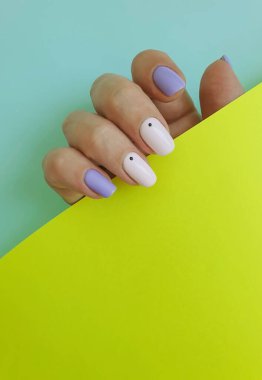 Kadın eli. Renkli arka planda güzel manikür.