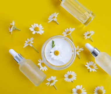 krem kozmetik papatya çiçeği renkli arka planda