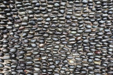 Yumuşak, nemli nehir taşlarının yakın çekimi doğal dokulu bir zemin oluşturuyor. Spa, zen ve doğa temalı tasarımlar için mükemmel..