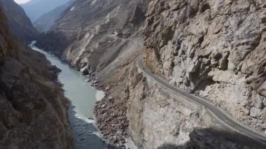 Aerial view of a winding road through a mountainous canyon in Pakistan, highlighting the rugged beauty of the landscape.