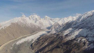 Aerial view of a majestic glacier nestled in the snow-capped mountains of Pakistan, highlighting the pristine beauty of the Himalayan landscape.