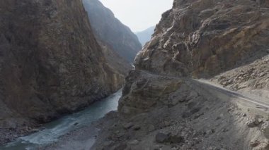 Aerial view of a winding road through a dramatic canyon in Pakistan, highlighting the rugged beauty of the Karakoram Highway.