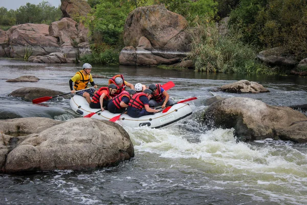 Myhiya / Ukrayna - 24 Haziran 2018: Grup Kılavuzu whitewater rafting ve nehir üzerinde turistik, aşırı ve eğlenceli spor kürek ile mutlu insan. Pivdennyi Buh nehirde rafting