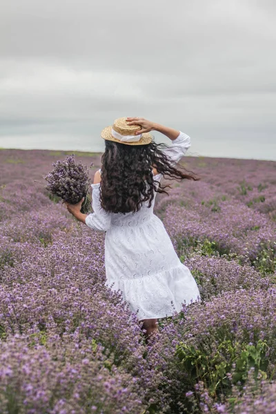 Girl in a white dress on a lavender field