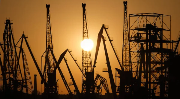 Silhouettes of port cranes at sunset. Cargo port Odessa, Ukraine